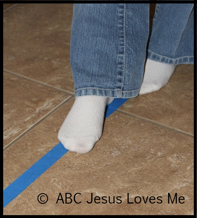 Walking on painter's tape on the floor.