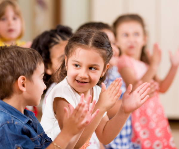 Group of preschool children clapping.