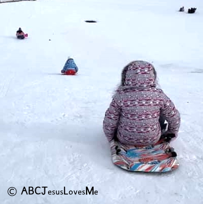 Children sledding in the snow