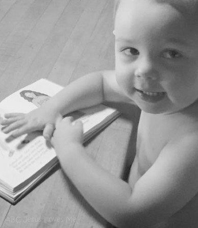 A child reading a children's Bible.